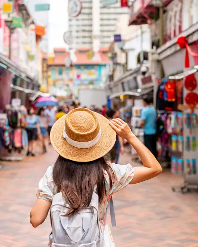 young-female-tourist-walking-in-chinatown-street